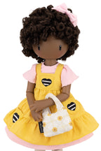 Doll with curly hair, yellow dress, and on a white background