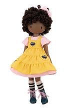 Doll with yellow dress on a white background