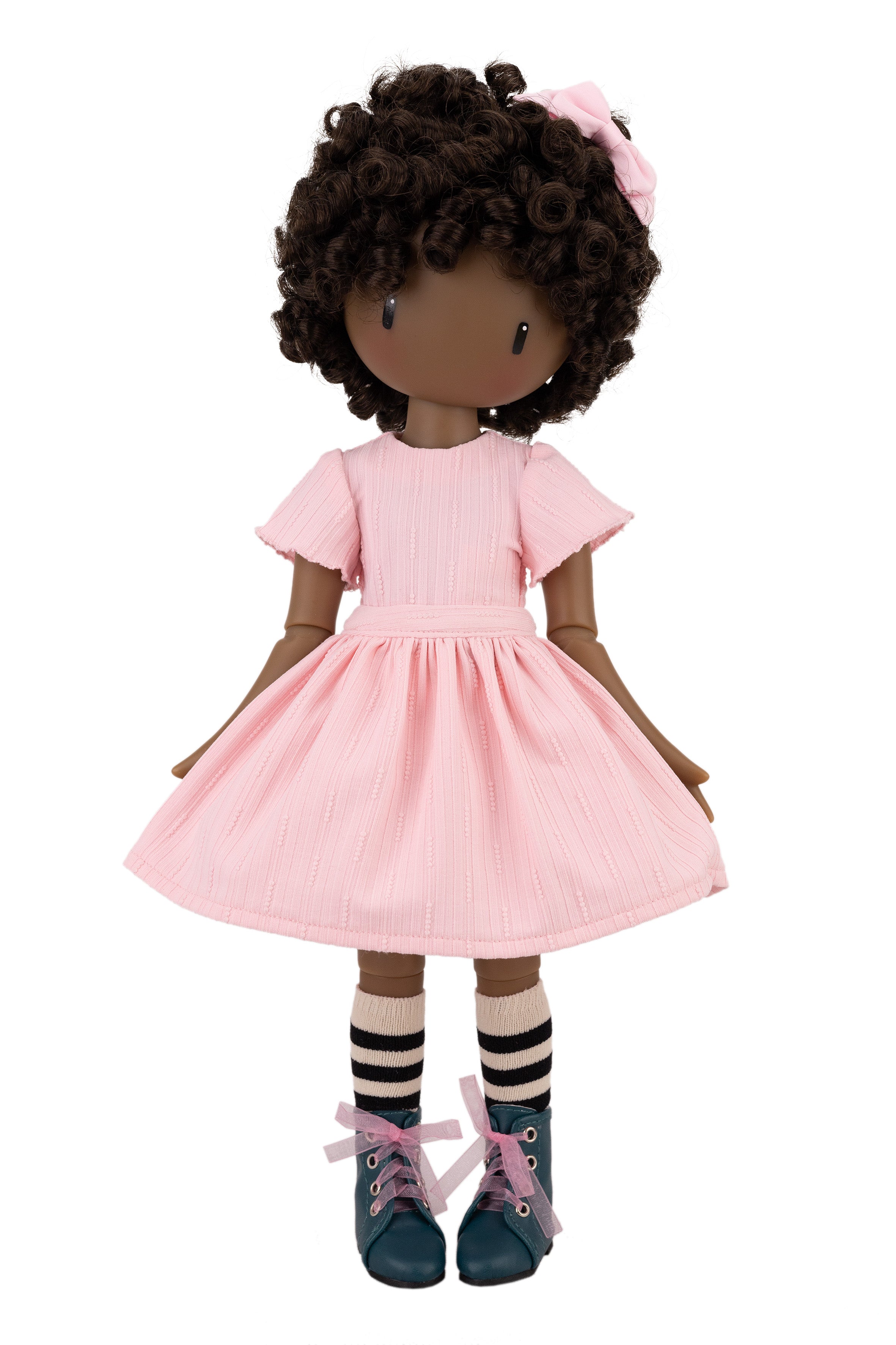 Doll with pink dress and curly hair on a white background