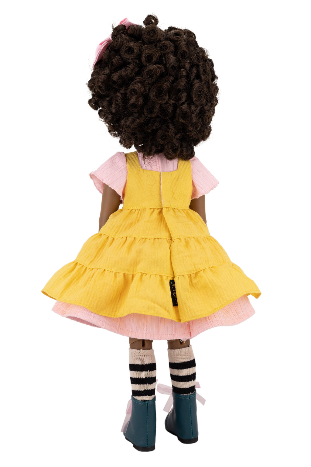Doll wearing a yellow dress on a white background