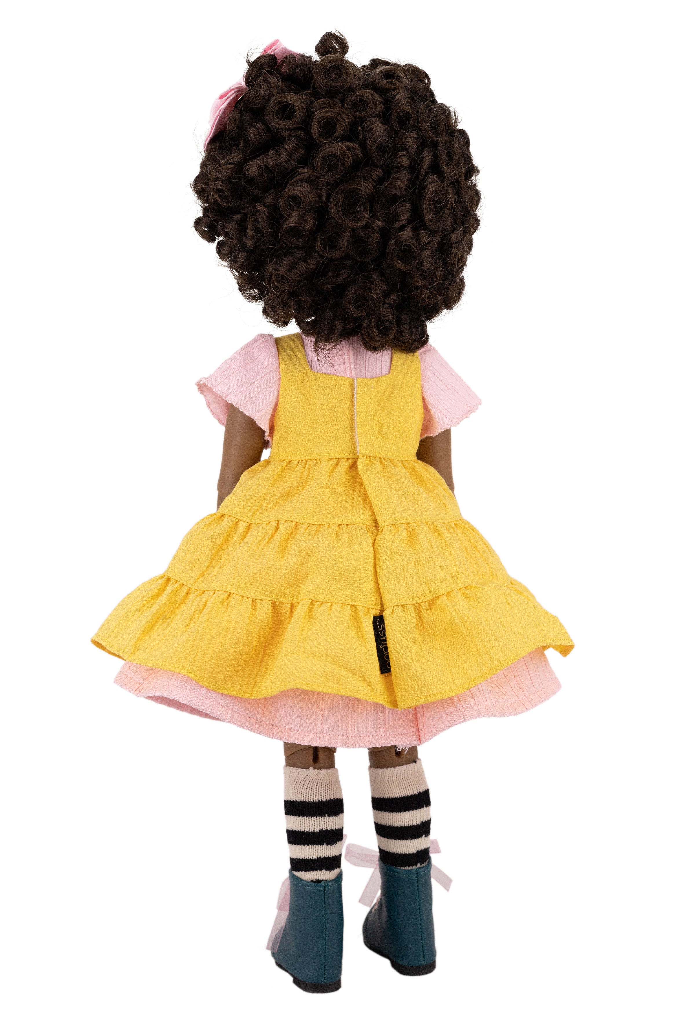 Doll wearing a yellow dress on a white background