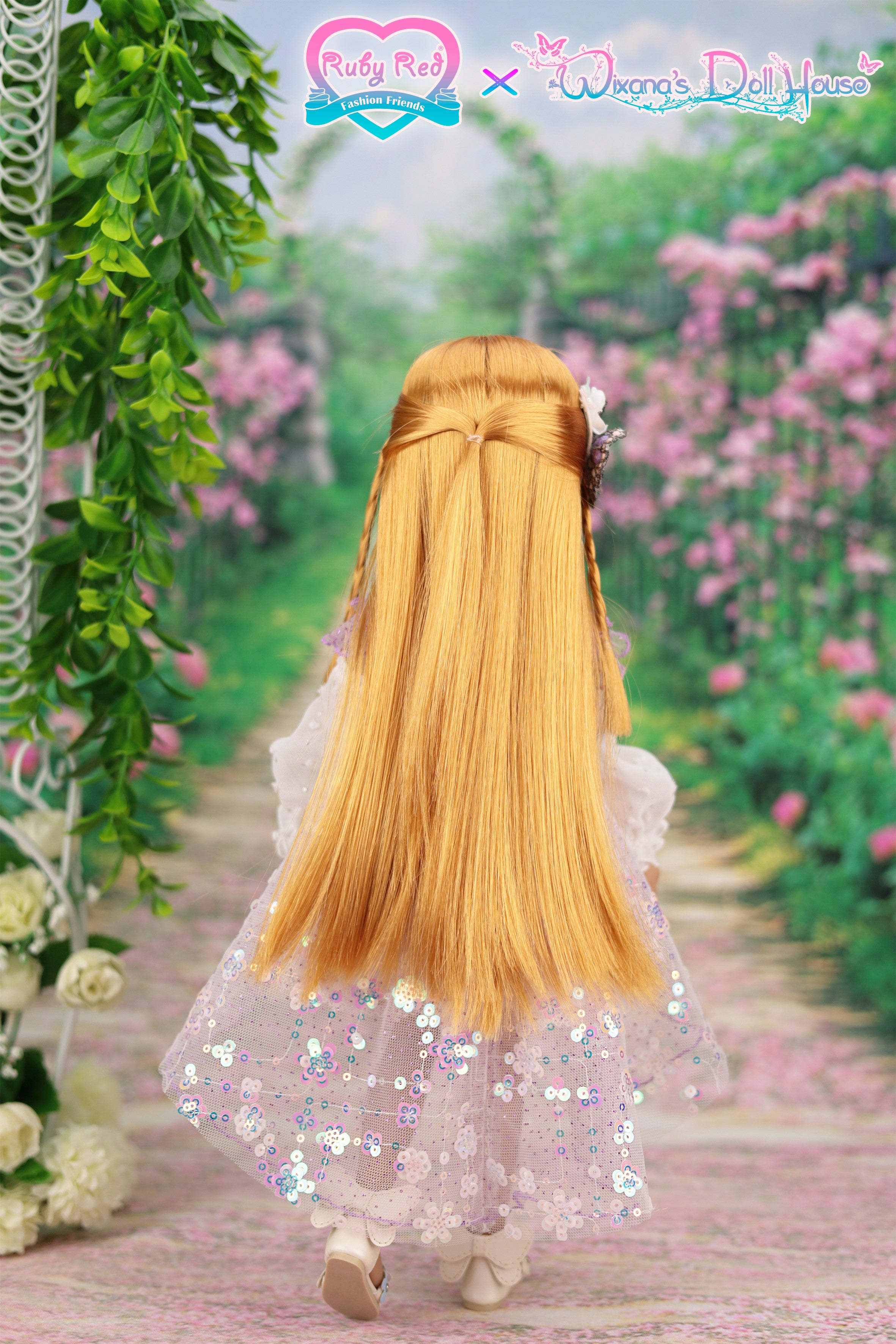 Doll with long blonde hair and a sparkly dress standing in a garden with pink flowers and greenery.