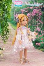 Doll in a pink dress with floral patterns standing on a path with flowers and greenery.