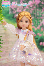 Doll in a white and pink dress with floral details standing in a garden setting.