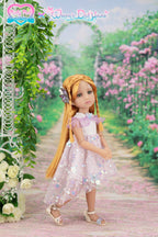 Doll in a pink dress standing on a path with flowers and greenery