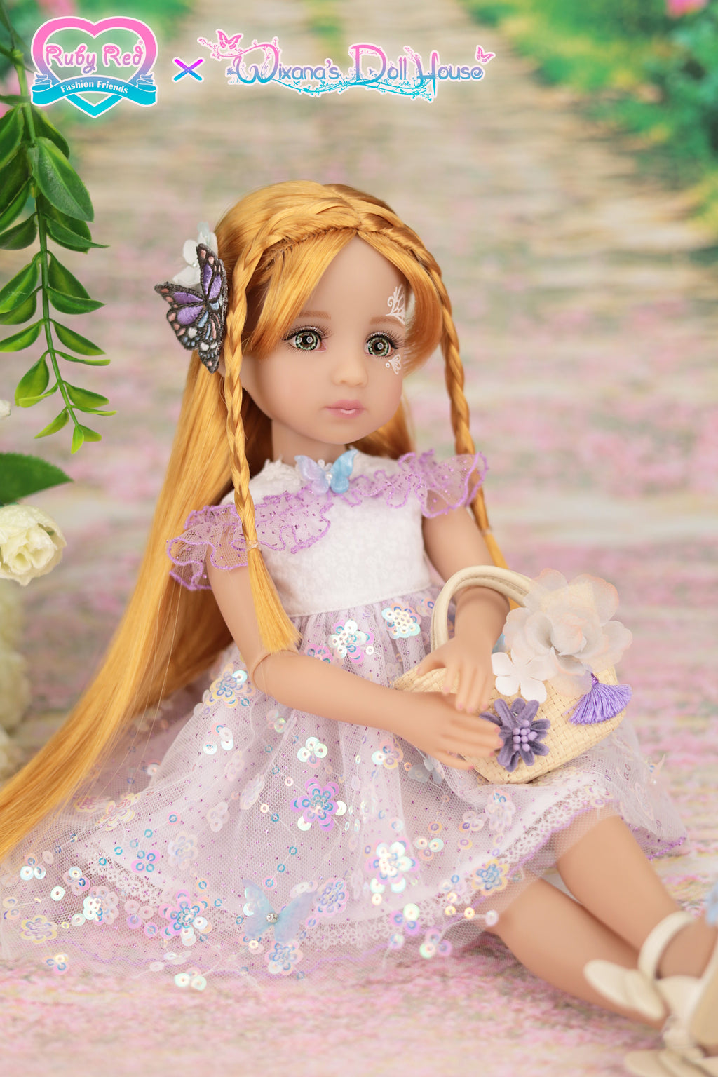 Doll in a pink dress with a butterfly hair accessory and floral bag, sitting on a pink surface with greenery.