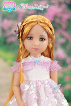 Doll with blonde hair and a pink dress in a garden setting