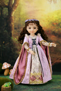 Doll in a detailed historical dress with a forest background