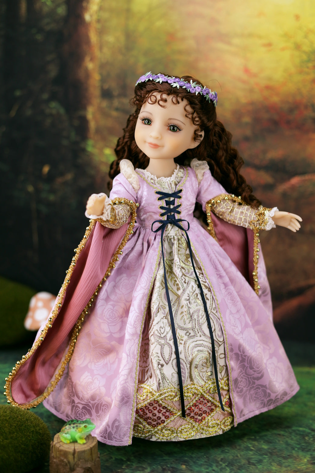 Doll in a detailed historical dress with a forest background
