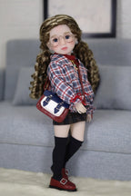 Doll with glasses and plaid outfit standing on a couch