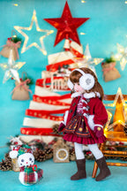 Doll in festive outfit with Christmas tree and decorations