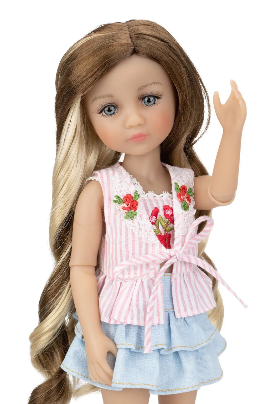Doll wearing a pink and white striped dress with floral embroidery on a white background