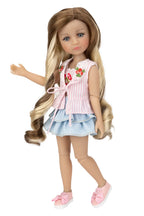 Doll with long hair wearing a pink top and blue skirt on a white background