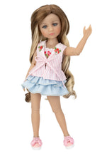 Doll with long brown hair wearing a pink floral top and blue skirt on a white background