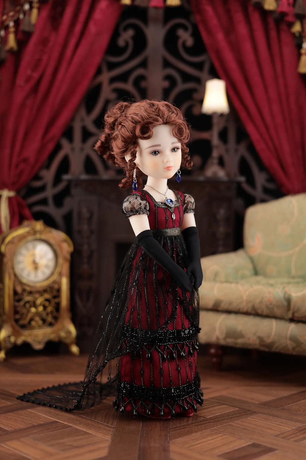 Doll in a red dress with black accents in a decorative room