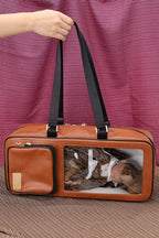 Brown pet carrier with a black handle against a striped purple and brown background