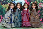 Four dolls in vintage-style dresses with a floral background