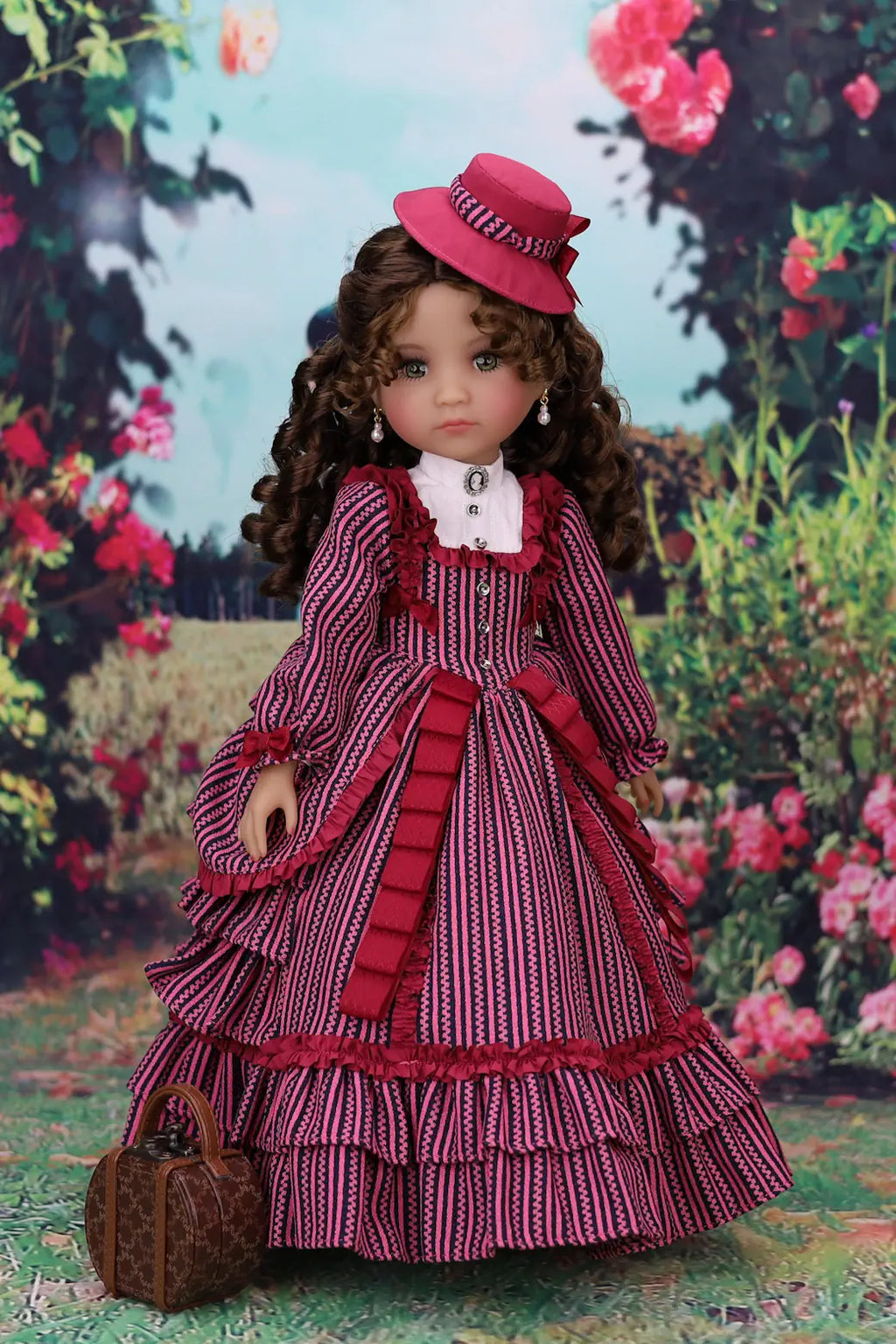 Doll in a red and white dress with a Magenta hat against a floral background