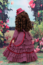 Doll in a vintage-style dress with a magenta hat against a floral garden backdrop