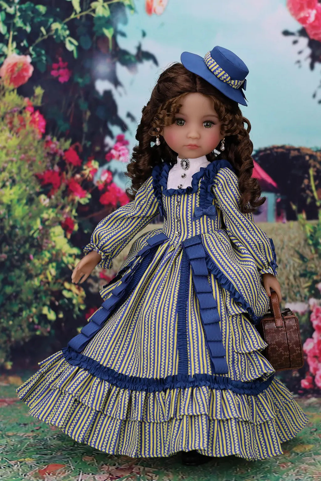 Doll in a vintage dress with blue accents standing in a garden setting
