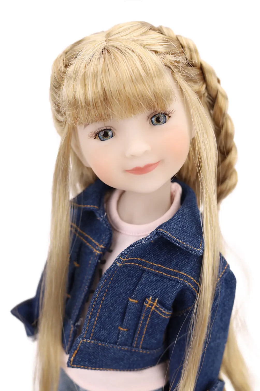 Doll with blonde hair styled in braids wearing a denim jacket on a white background