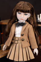 Doll wearing a brown coat and skirt with a white shirt and black bow tie.