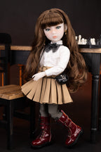 Doll with long brown hair, white blouse, beige pleated skirt, and red boots in a dark setting.