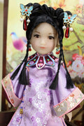Traditional Chinese doll with intricate hair accessories and clothing against a floral background