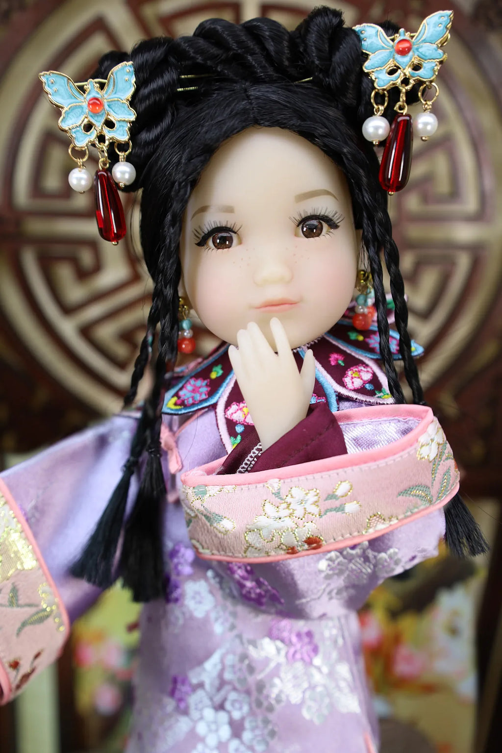 Traditional Chinese doll with intricate hair accessories and kimono