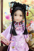 Traditional doll in a decorative setting with floral and bird elements