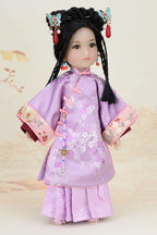 Traditional doll in a purple outfit with floral patterns on a light background