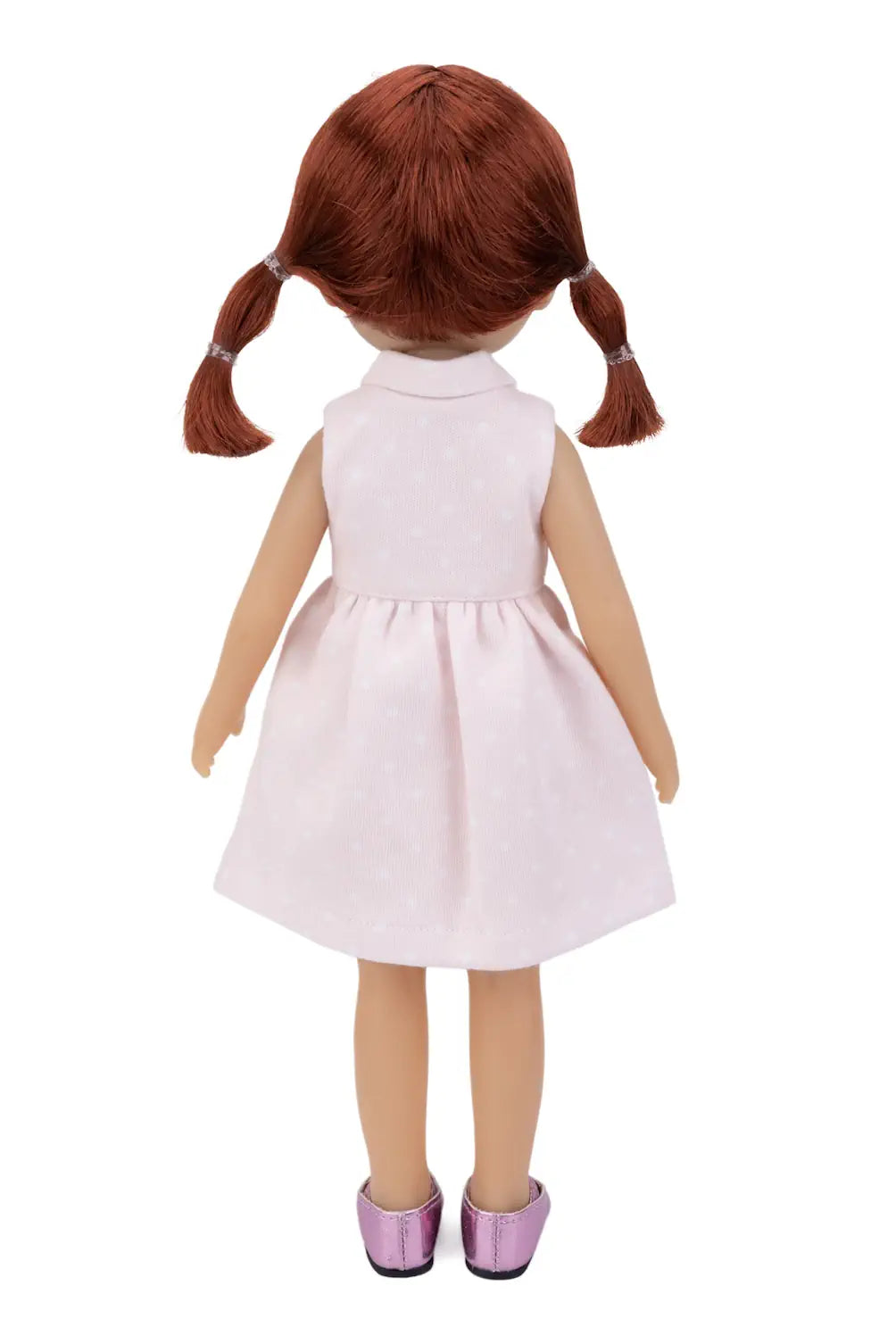 Doll with red hair in pigtails wearing a white dress on a white background