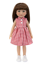 Doll wearing a red and white checkered dress on a white background
