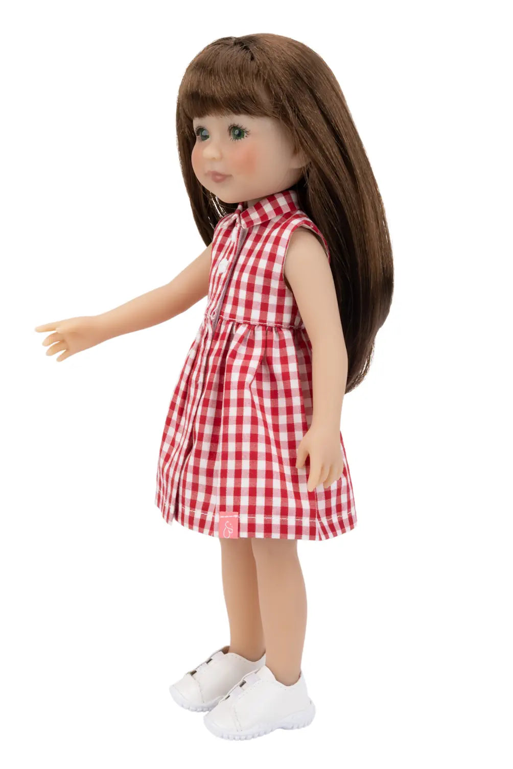 Doll wearing a red and white checkered dress on a white background