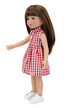 Doll wearing a red and white checkered dress on a white background