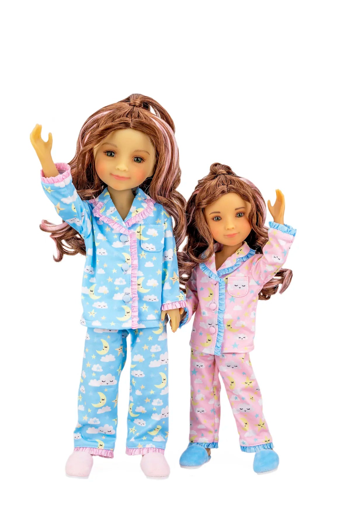 Two dolls wearing matching pajama sets on a white background