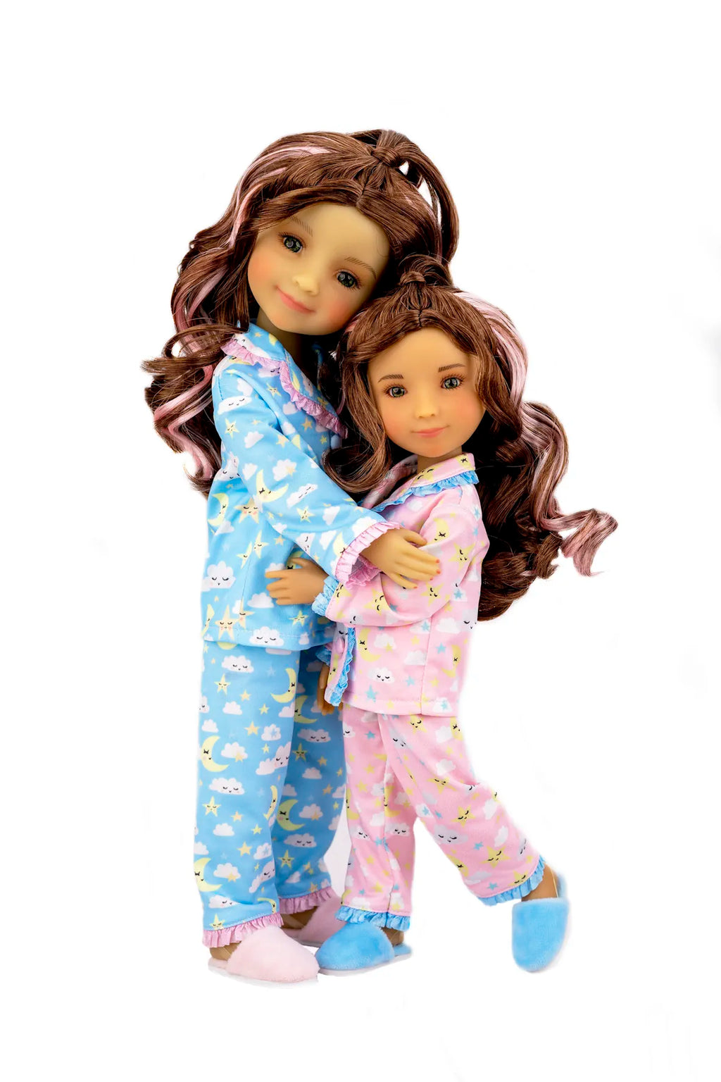 Two dolls wearing matching pajamas with a white background