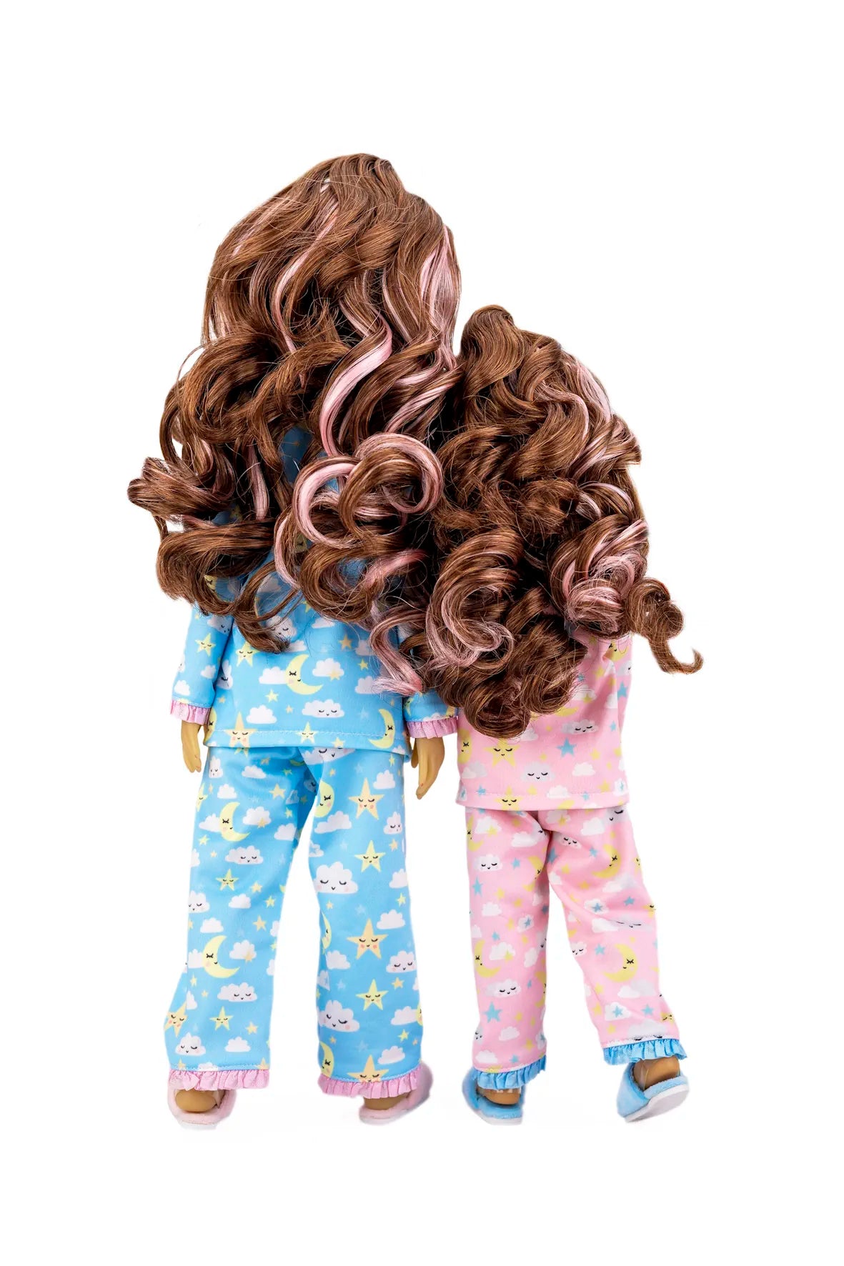 Two dolls wearing pajamas with cloud and star patterns on a white background