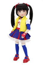 Doll with long black hair styled in pigtails, wearing a colorful outfit with a yellow vest, blue skirt, and red shoes on a white background.