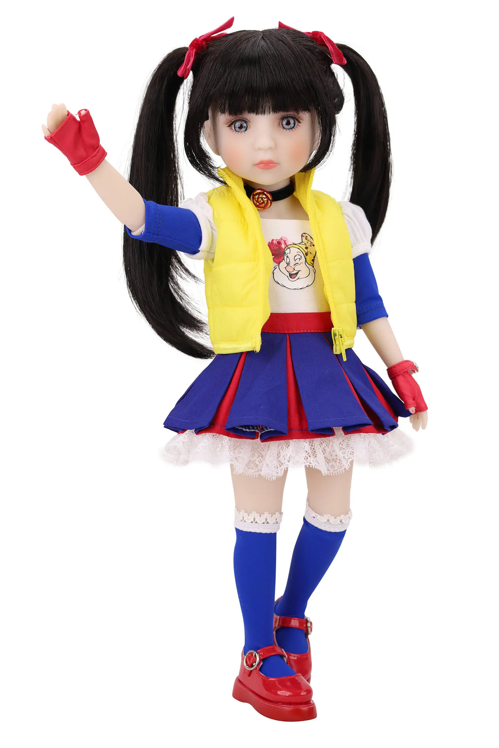 Doll with long black hair styled in pigtails, wearing a colorful outfit with a yellow vest, blue skirt, and red shoes on a white background.
