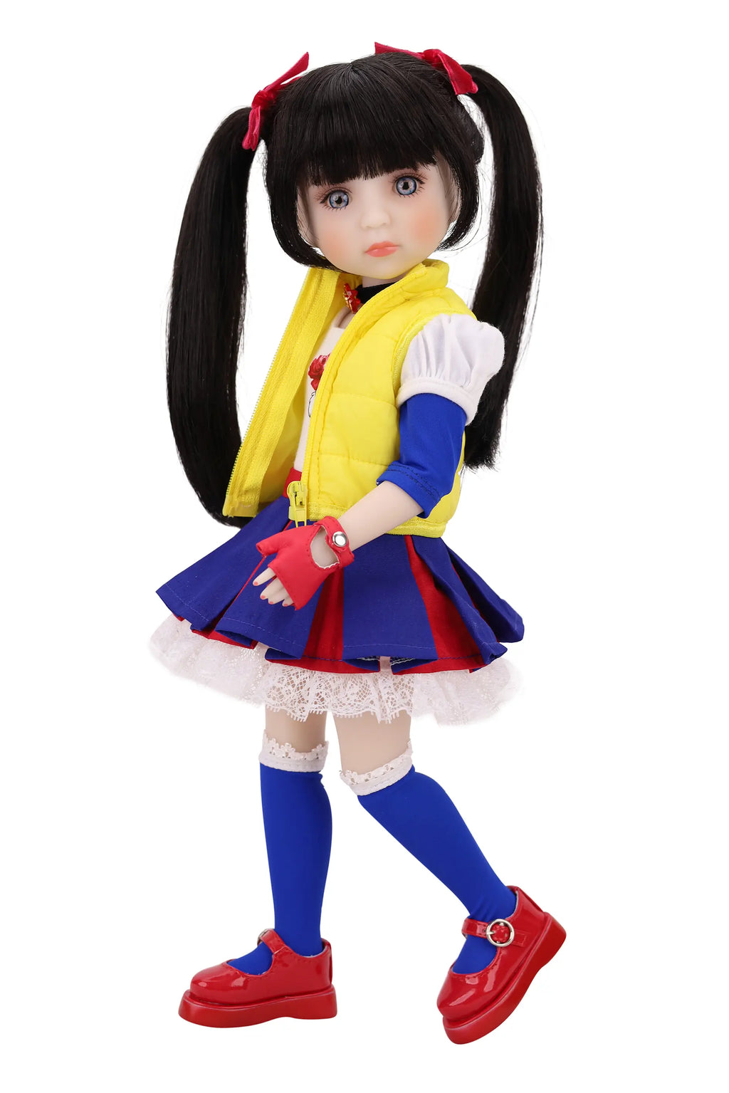 Doll in a colorful outfit with a yellow vest, blue skirt, and red shoes on a white background.