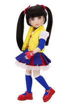 Doll in a colorful outfit with a yellow vest, blue skirt, and red shoes on a white background.