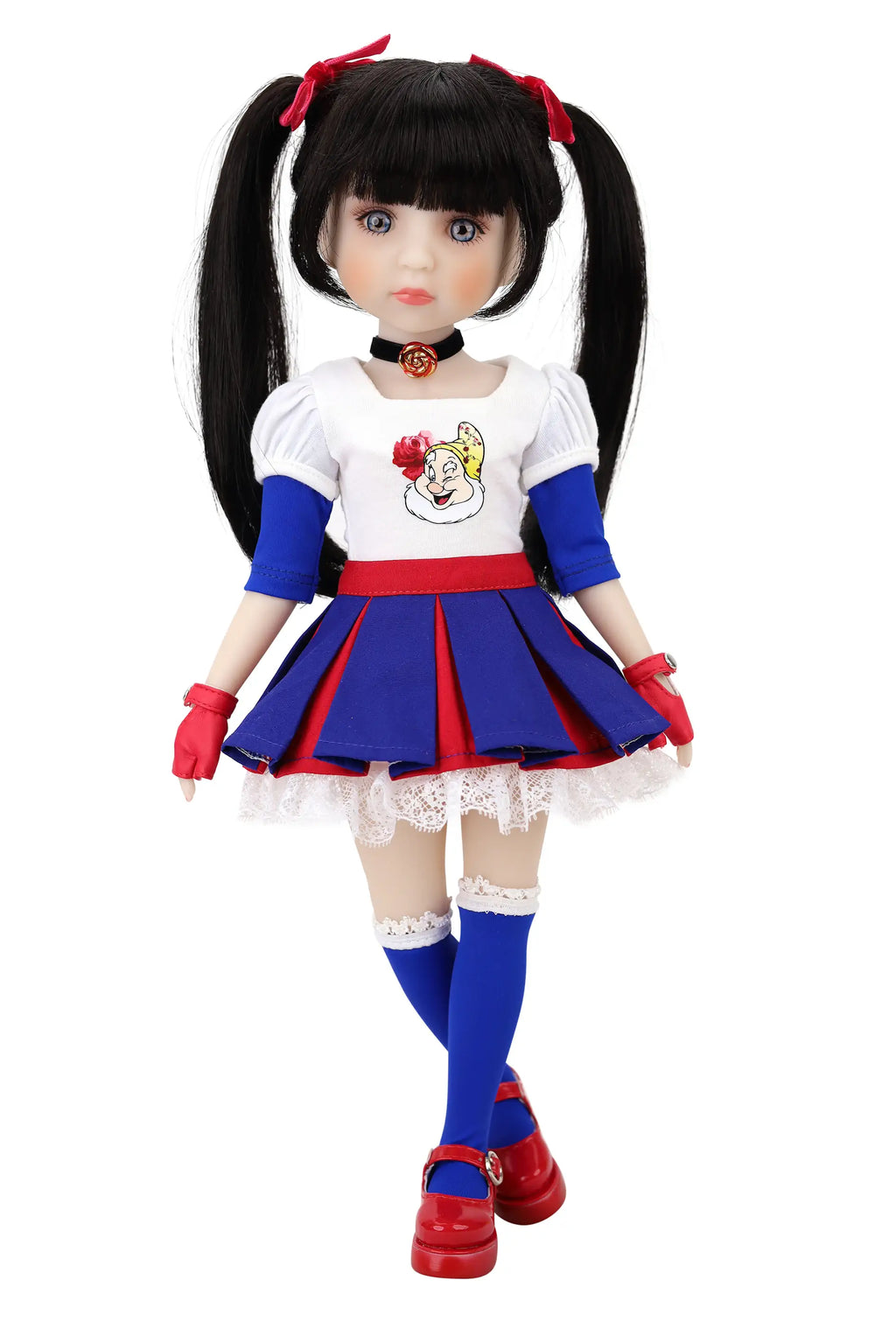 Doll with black hair styled in pigtails, wearing a white top with a cartoon character, blue skirt, red shoes, and red gloves on a white background.