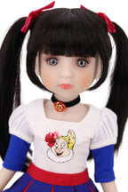 Doll with black hair styled in pigtails, wearing a white shirt with a cartoon character.