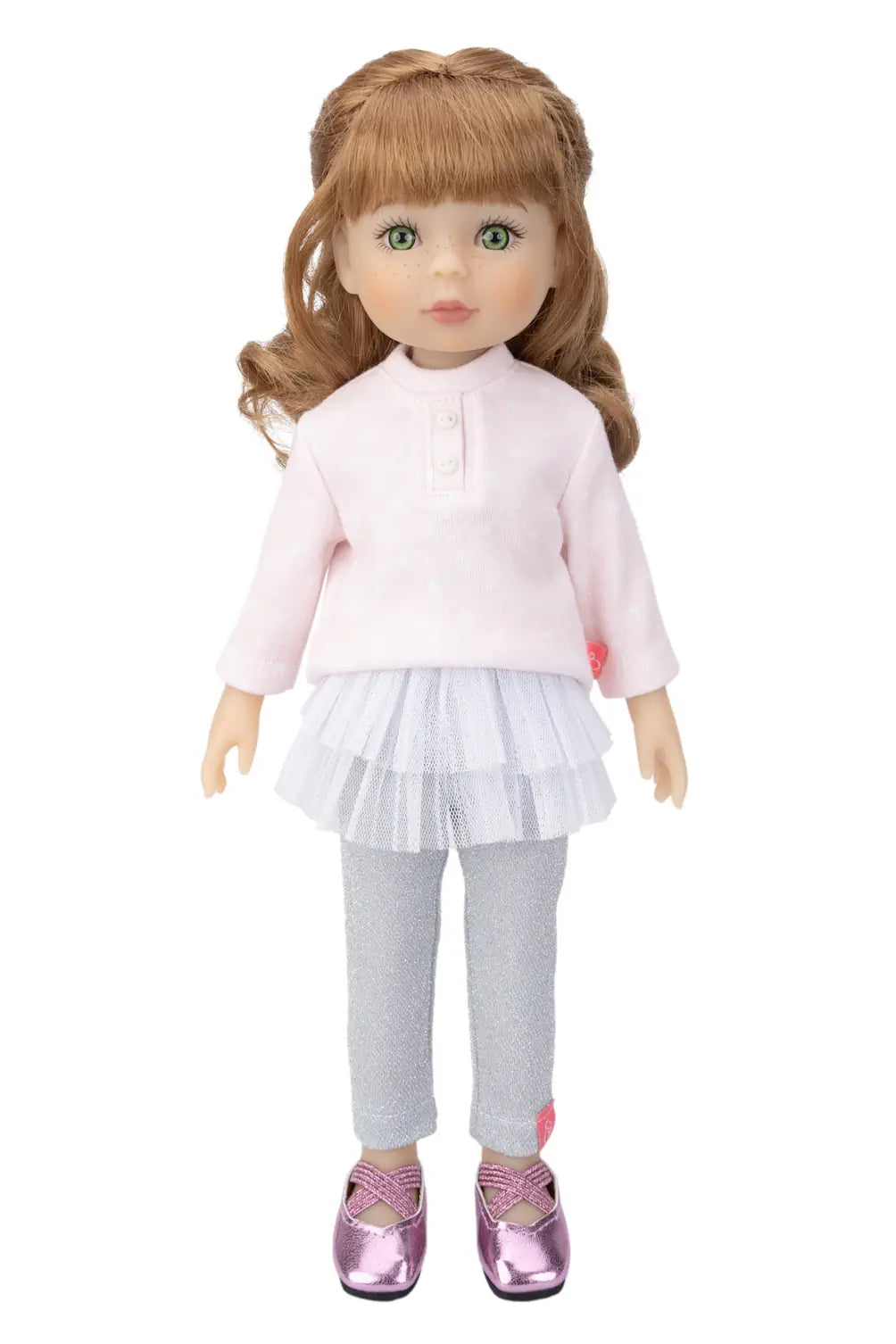Doll wearing a pink shirt, white skirt, silver leggings, and pink shoes on a white background