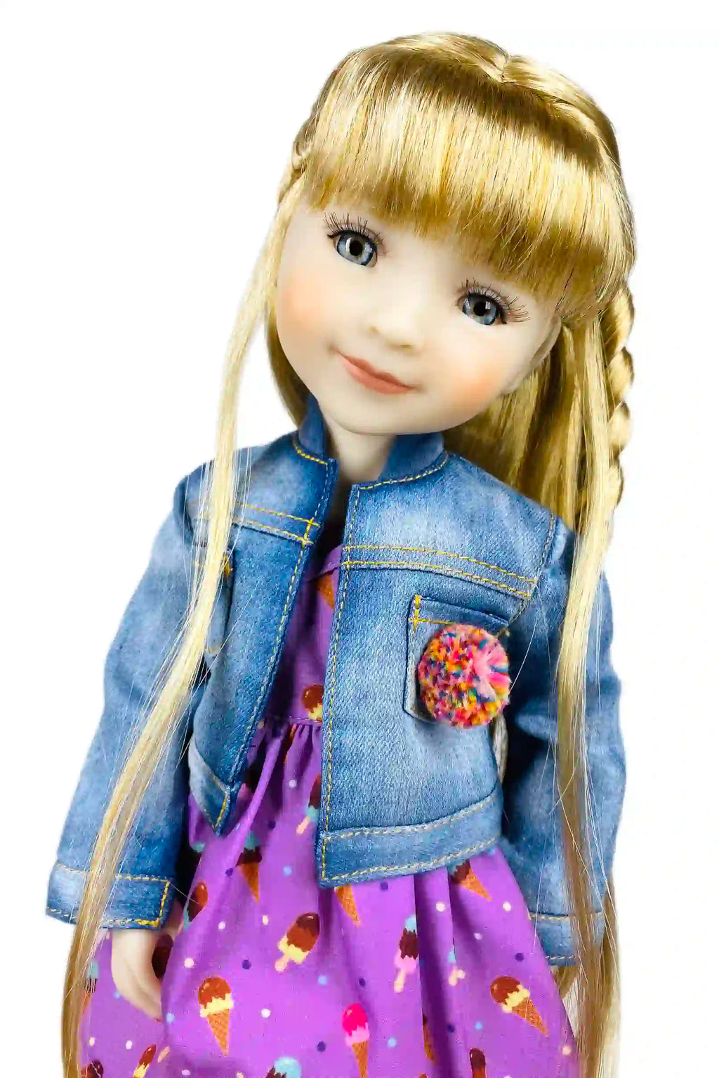 Doll with blonde hair, denim jacket, and purple dress with ice cream pattern on a white background