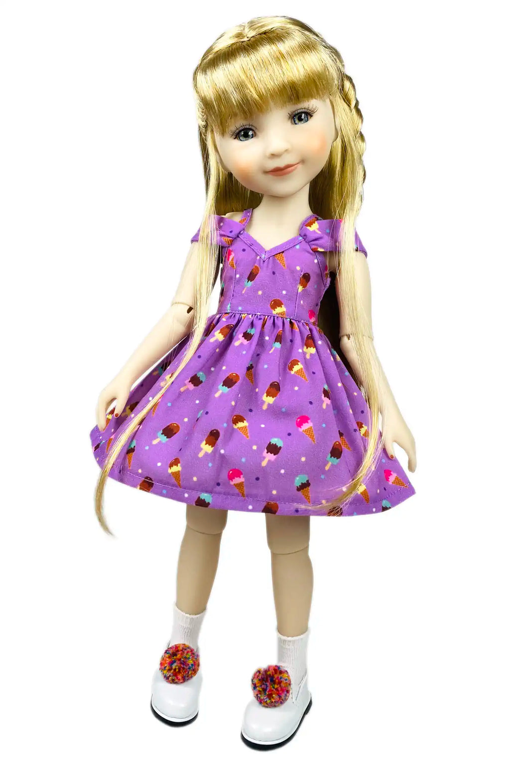 Doll wearing a purple dress with ice cream cone pattern on a white background