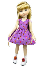 Doll wearing a purple dress with ice cream cone pattern on a white background
