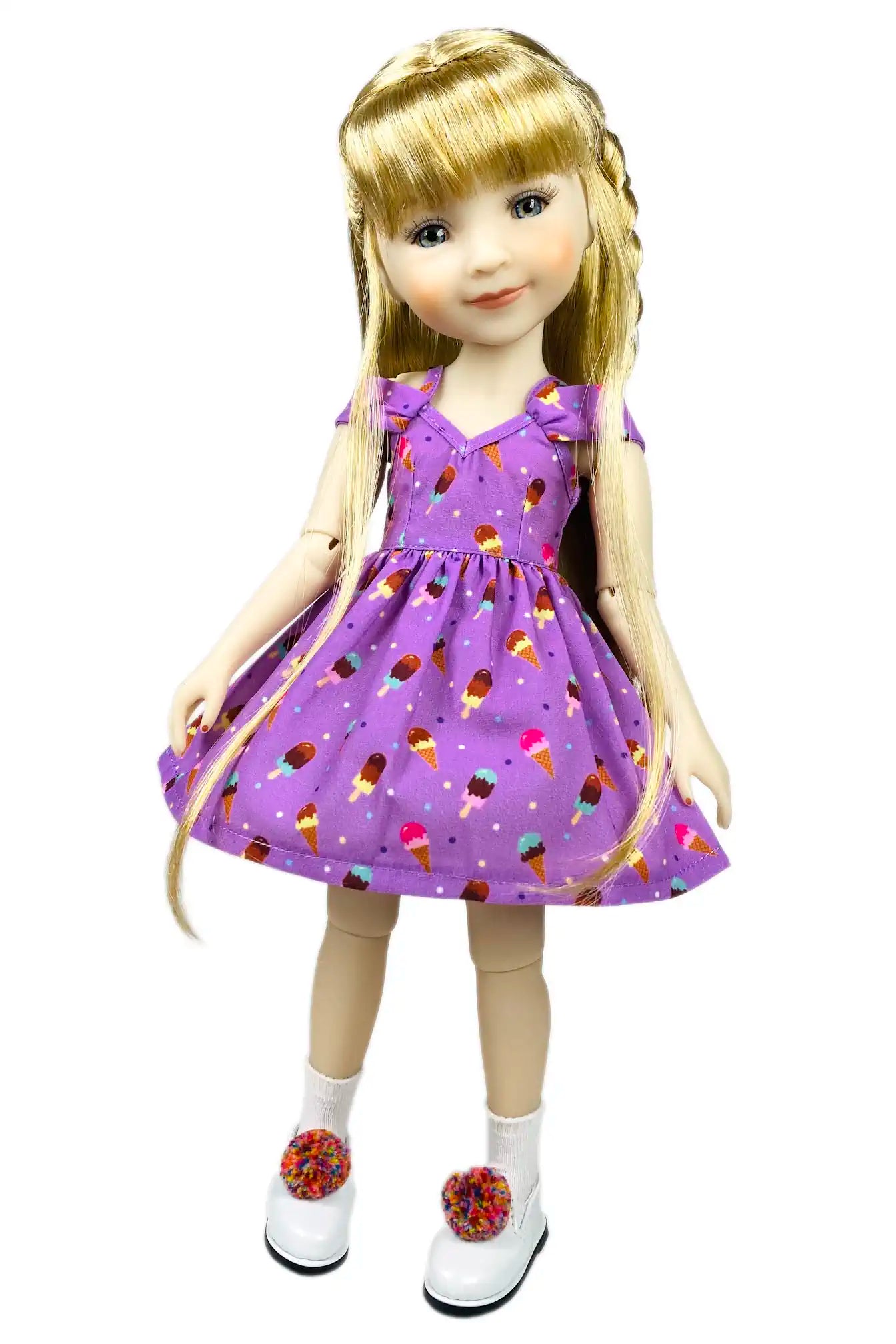 Doll wearing a purple dress with ice cream cone pattern on a white background