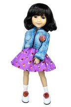 Doll wearing a denim jacket and purple dress with ice cream pattern on a white background